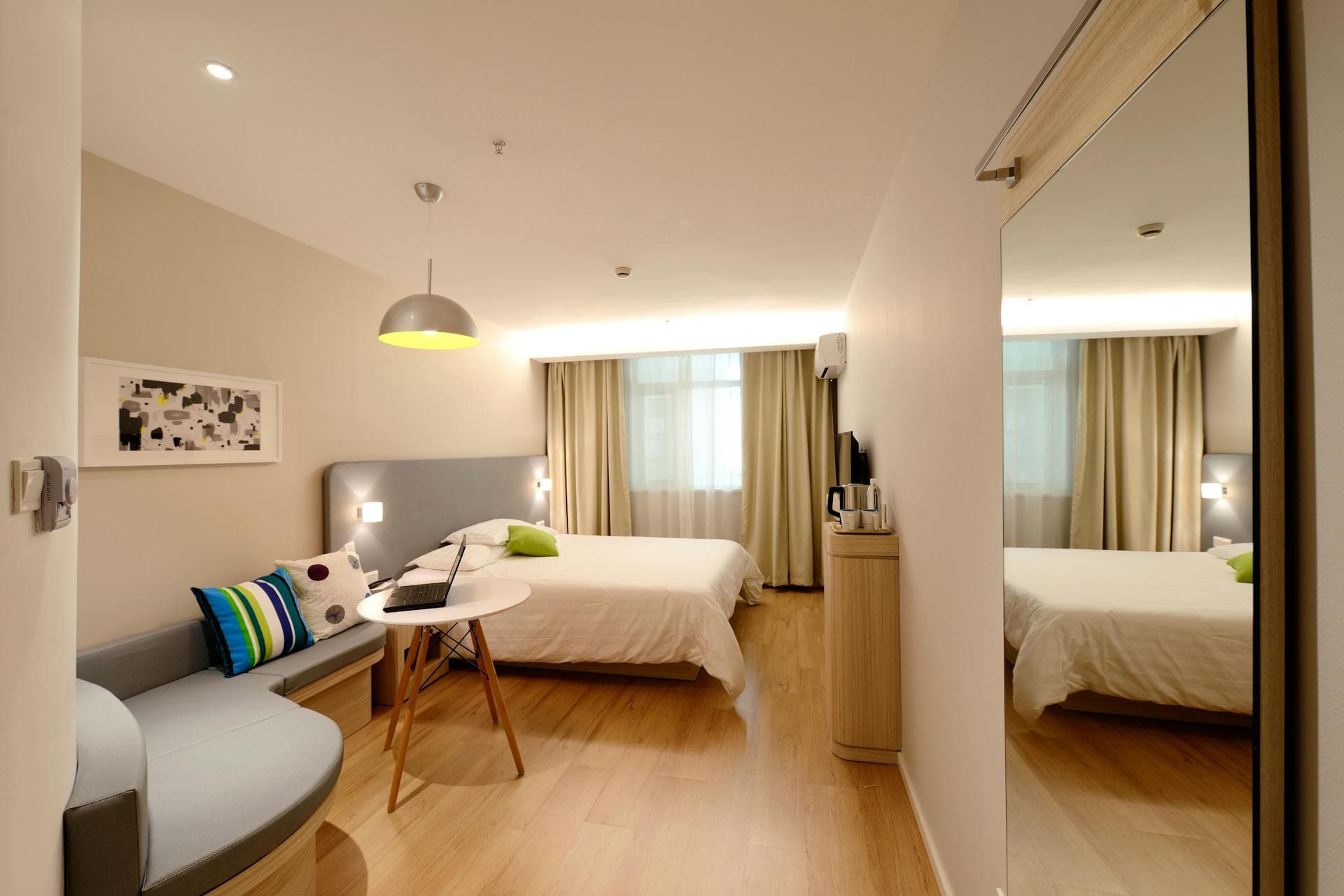 Clean, well-maintained hotel bedroom with white bedding, representing bed bug prevention standards for hospitality properties