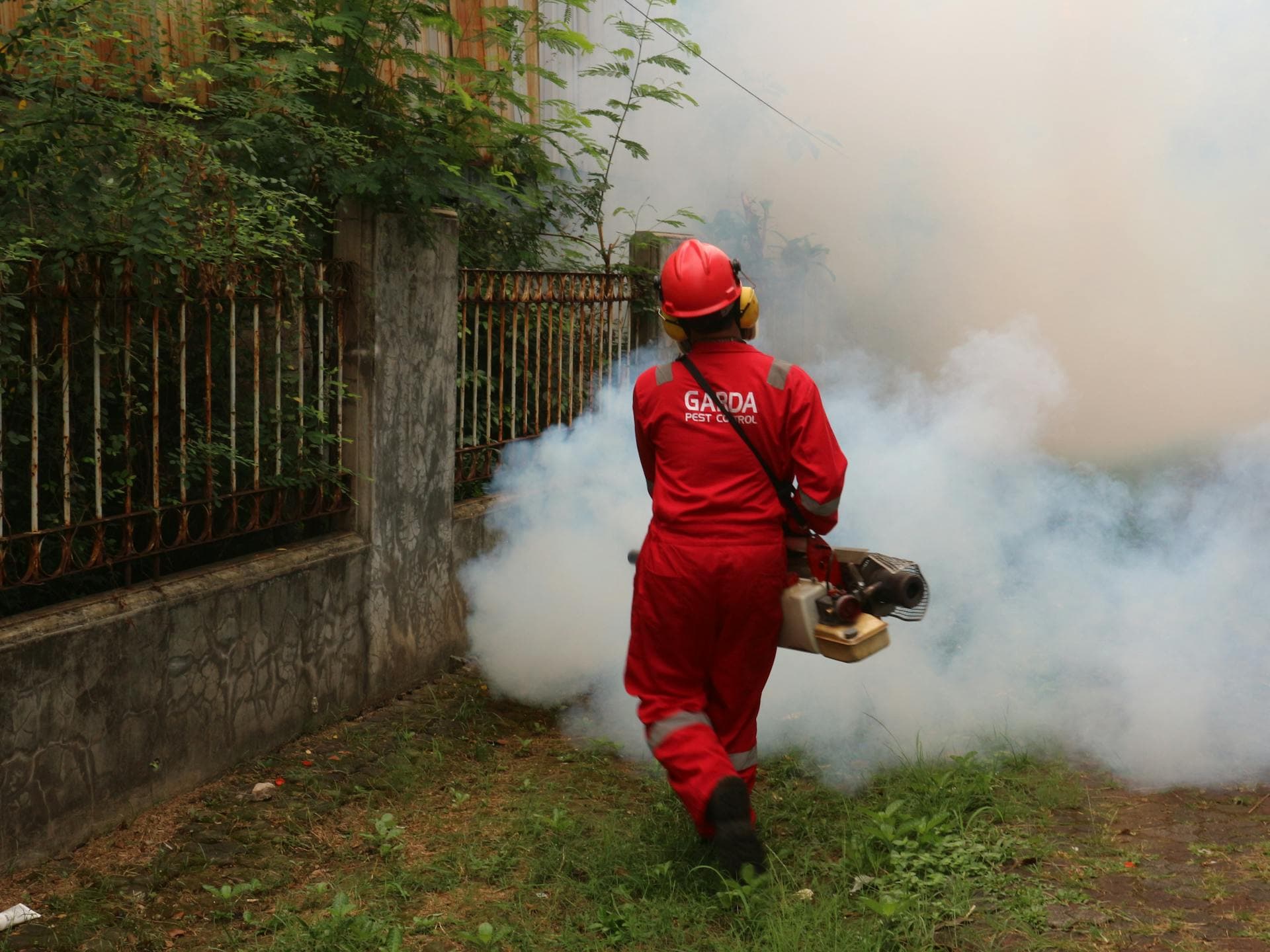 Pest control technician performing emergency treatment at a Florida home