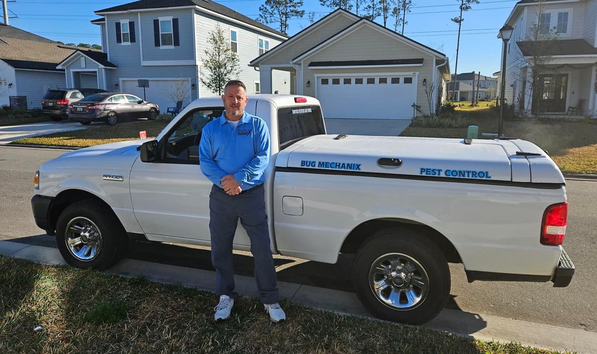Joseph, owner of Bug Mechanix Pest Control, with company truck